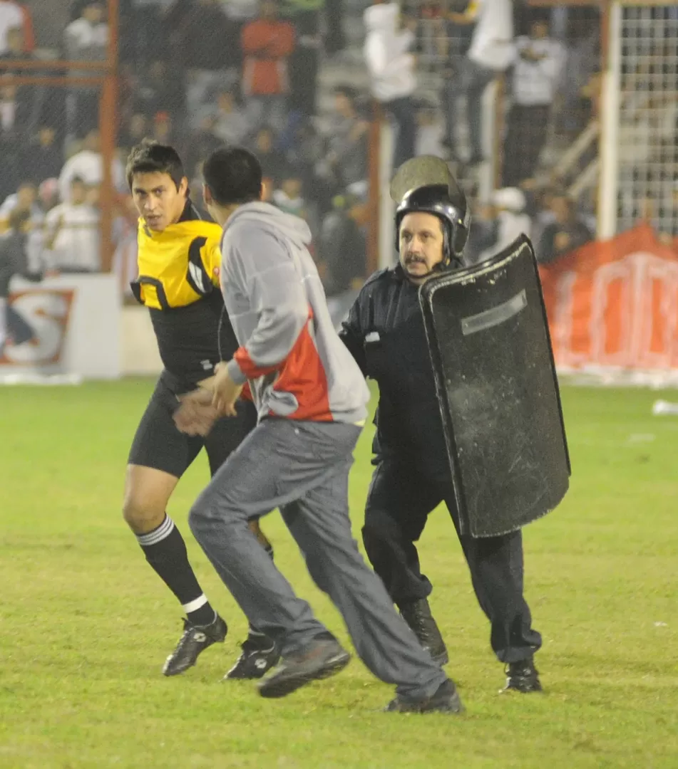 FINAL CALIENTE. Un hincha ingresó al campo de juego e intentó sacarle la ropa a Pave. También hubo insultos. LA GACETA / FOTO DE ANTONIO FERRONI