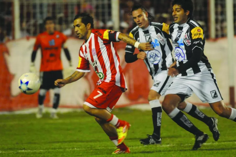 ACORRALADO. Gustavo Ibáñez lleva la pelota perseguido por Ramiro Jorge. El Ratón aportó muy poco para el equipo de La Ciudadela. LA GACETA / ENRIQUE GALINDEZ