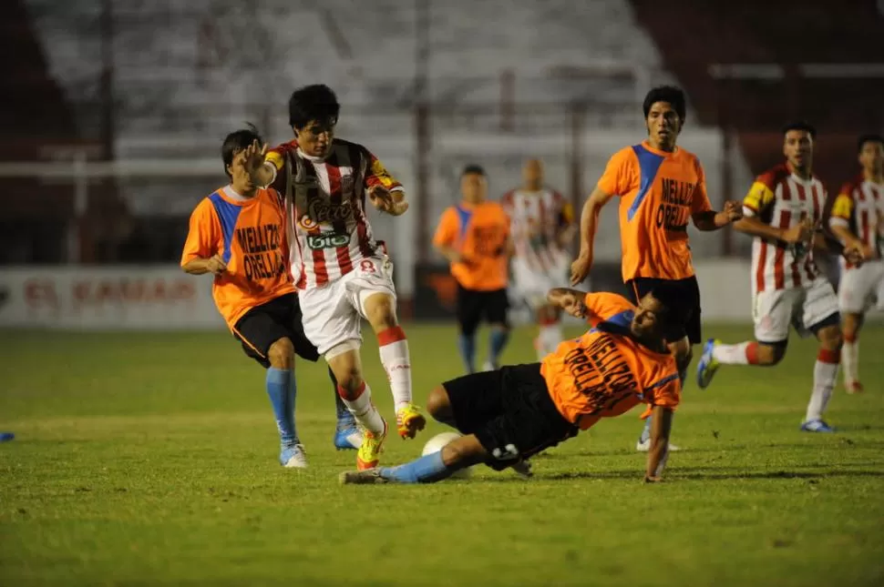 A TODO O NADA. Darío Juan se arroja al piso para tratar de frenar un ataque de Nicolás Roldán. El volante de los santos marcó un gol y mostró un buen nivel de juego en el debut del santo en la Copa. 