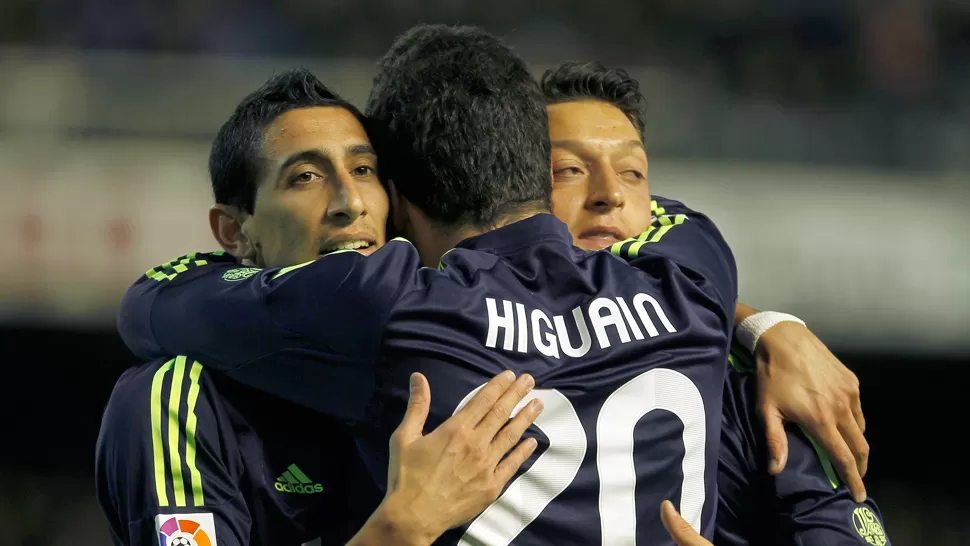 GOLEADOR. Pipita y Fideo celebran junto al alemán Özil uno de los goles que le dieron la victoria de los madrileños. REUTERS