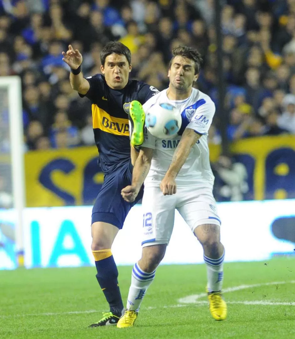 LUCHA SIN CUARTEL. Con una patada casi voladora, Caruzzo intenta desacomodar a Pratto que la recibe durante el segundo tiempo en La Bombonera. 