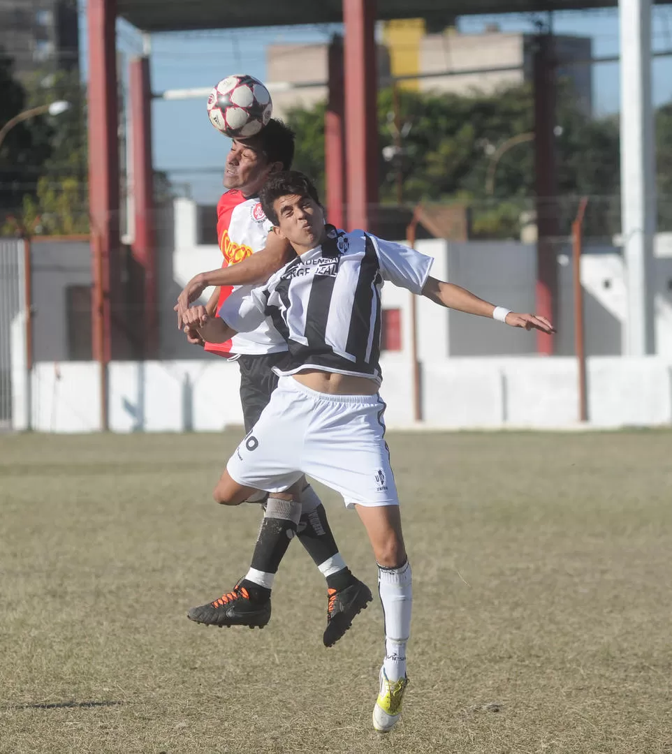 DUELO EN LAS ALTURAS. Lizárraga, de Sportivo, le gana en el salto y despeja de cabeza ante la marca de Galván, de Unión. 