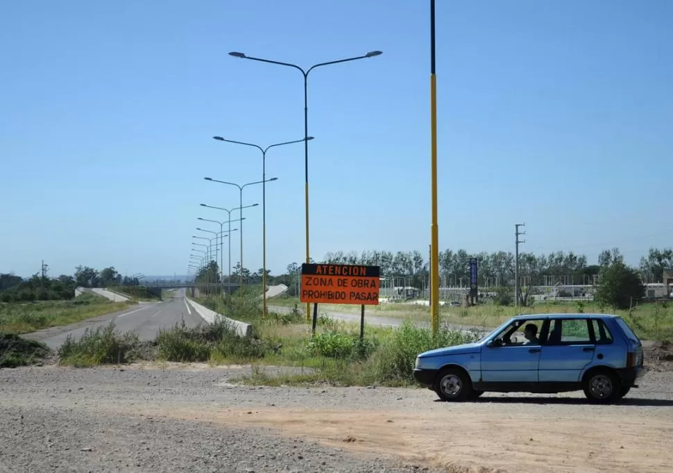 ENTRADA AL BARRIO UTA. Un conductor cruza la autovía por el sitio en donde se debería haber construido una rotonda que -es evidente- no existe. la gaceta / fotos de maria silvia granara 
