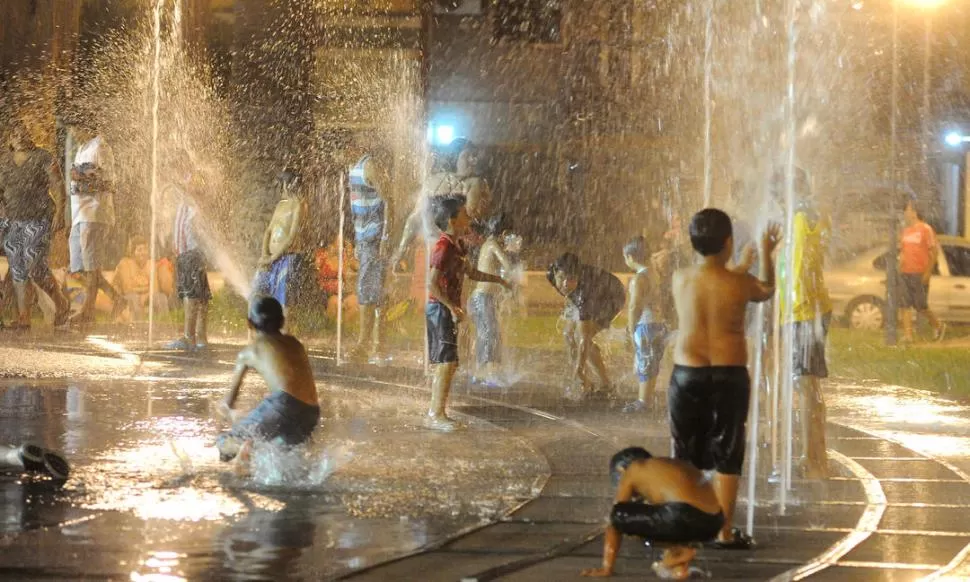 CARNAVAL TODA LA VIDA. Una multitud de chicas y chicos se apuran para jugar con las columnas de agua del monumento a Manuel Belgrano -que parece un balneario en plena costa- porque a las 23 deja de funcionar. la gaceta / fotos de Antonio Ferroni
