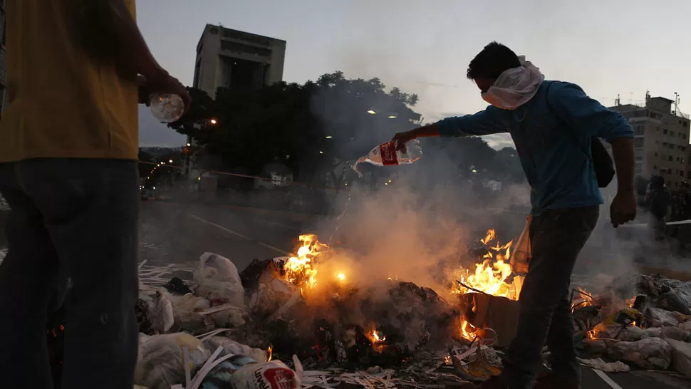 EN LLAMAS. Opositores, en la plaza Altamira, de Caracas. REUTERS