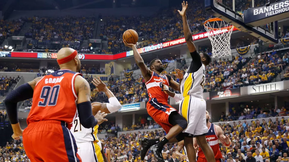 TREMENDO. Martell Webster entierra una volcada a pesar de la defensa que intenta Ian Mahinmi , de Pacers. REUTERS