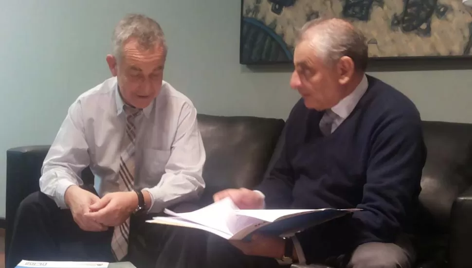 CONFORMES. Tamburo observa, satisfecho, la carpeta que exhibe Calvo. LA GACETA / FOTO DE JUAN PABLO DURAN