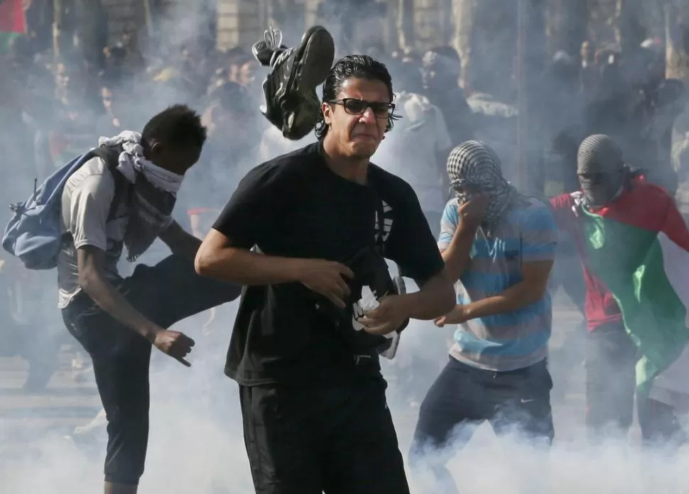 PARÍS. Un manifestante pierde un zapato en la marcha. fotos de reuters