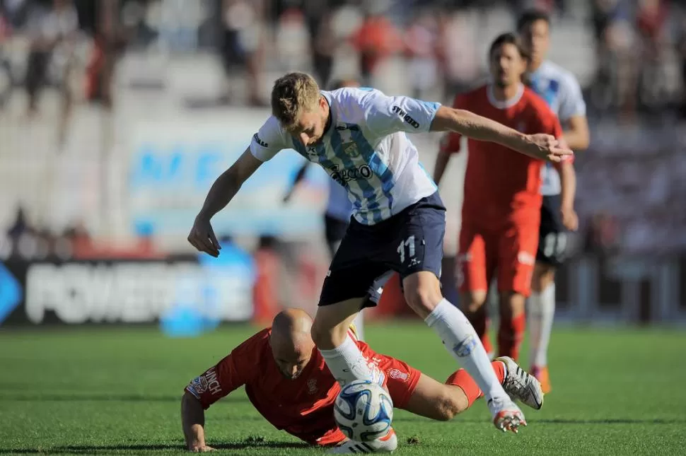 LE COSTÓ. El “Luchador” Menéndez, que le gana el balón a Mandarino, no tuvo chances de lastimar al arquero Díaz. 