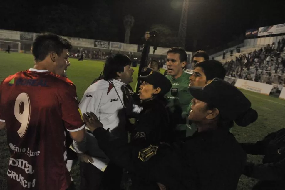 DISCUSIONES EN EL EPÍLOGO. Fabricio Lenci discute con el árbitro por un penal no cobrado y la policía lo retira a la fuerza. 