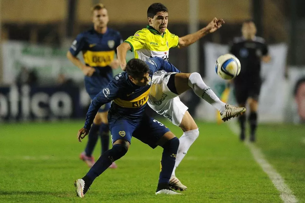 SE LAS BANCÓ A TODAS. El tucumano Sebastián Palacios aguanta la dura marca de un defensor de Sarmiento de Junín. télam