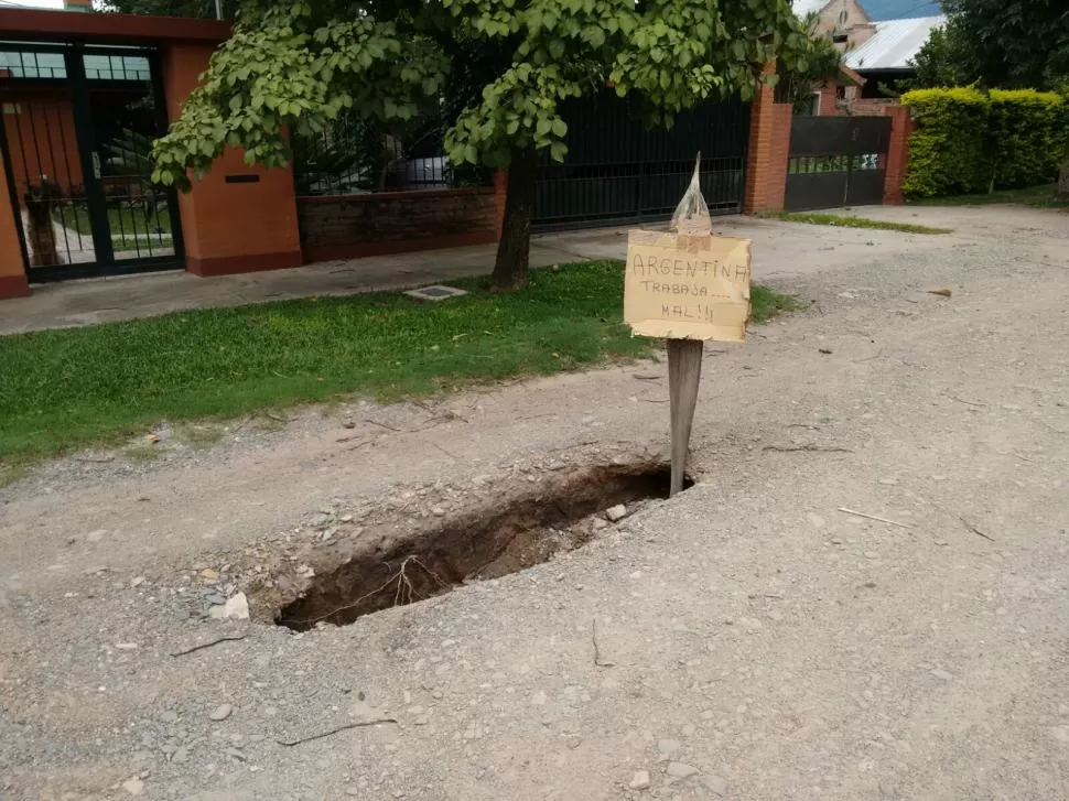 Aparecieron enormes baches en una calle de yerba buena