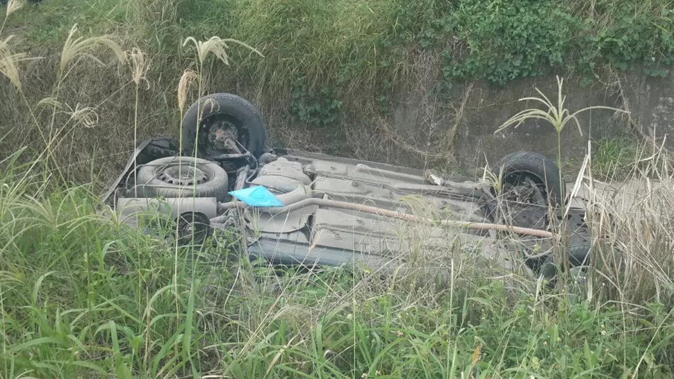 ACCIDENTE. Peugeot 206 gris, tirado en la banquina luego de volcar. FOTO ENVIADA POR UN LECTOR A LA GACETA.