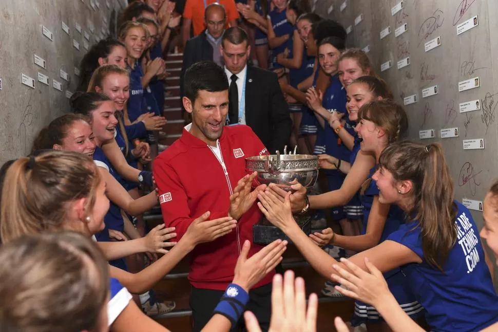 FELICIDAD TOTAL. Djokovic comparte su trofeo con los alcanzapelotas parisinos. reuters 