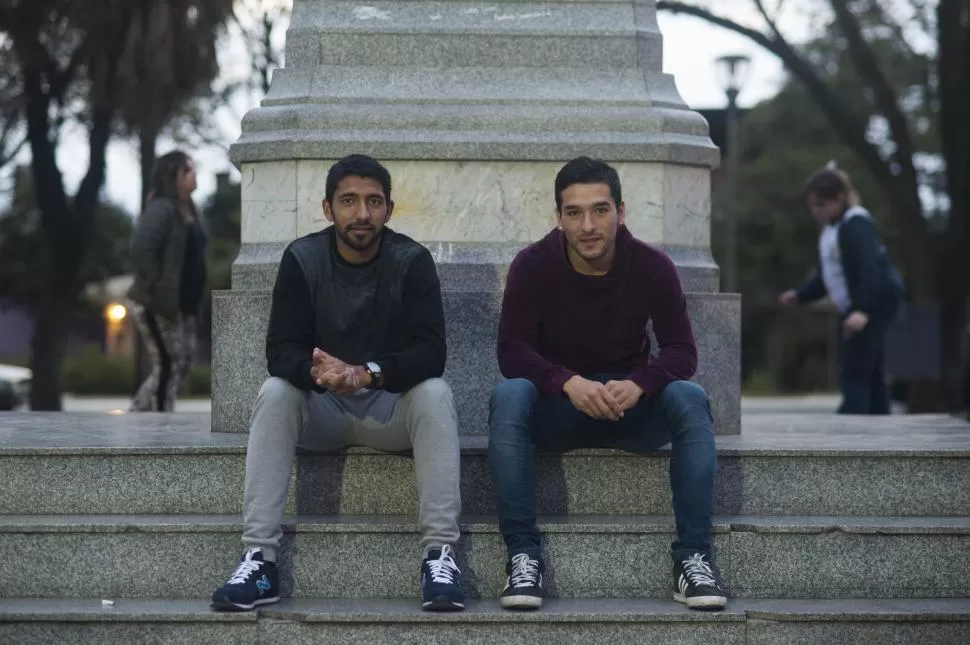 BUENA ONDA. García y Mendoza posan sentados al pie de la estatua de Manuel Belgrano, en la plaza que lleva su mismo nombre. Los refuerzos de Atlético y San Martín se enfrentarán esta noche.  la gaceta / foto de DIEGO ARáOZ