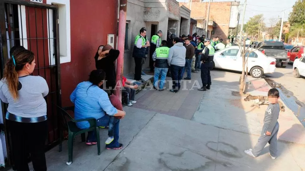 ESPECTADORES. Los vecinos hasta instalaron sillas en la vereda para seguir de cerca el allanamiento. En la imagen también se ve el taxi secuestrado. LA GACETA / FOTOS DE ANALÍA JARAMILLO