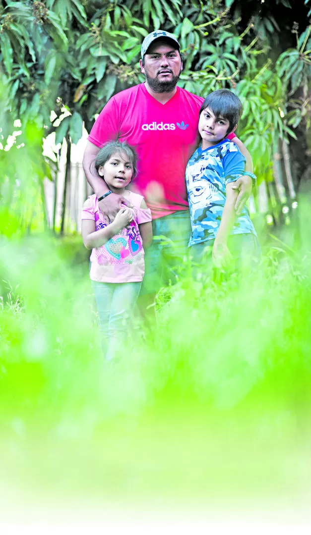 SUS PUNTALES. Nair y Elías, dos de los cuatro hijos de Monroy, posan orgullosos con su padre, en el patio de su casa. LA GACETA / FOTOS DE DIEGO ARÁOZ