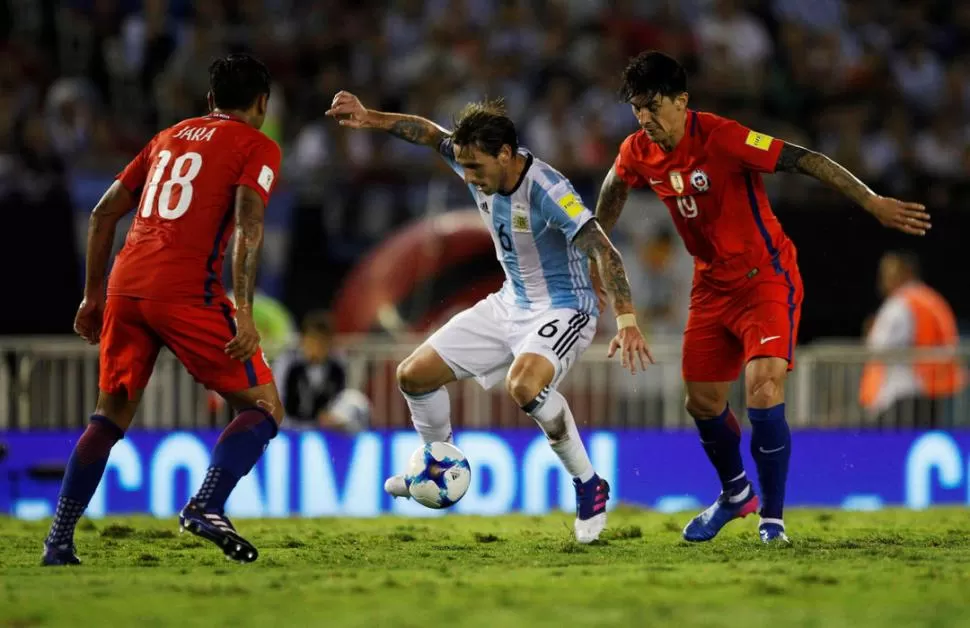 RODEADO. Biglia intenta, primero, dominar el balón y después encarará a Jara. Detrás suyo, el tucumano nacionalizado chileno Pablo Hernández intenta acercársele para robarle el balón. reuters 