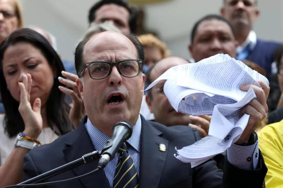 PAPEL EN MANO. Julio Borges, presidente de la Asamblea Nacional, rompe la disposición de la Corte Suprema. reuters