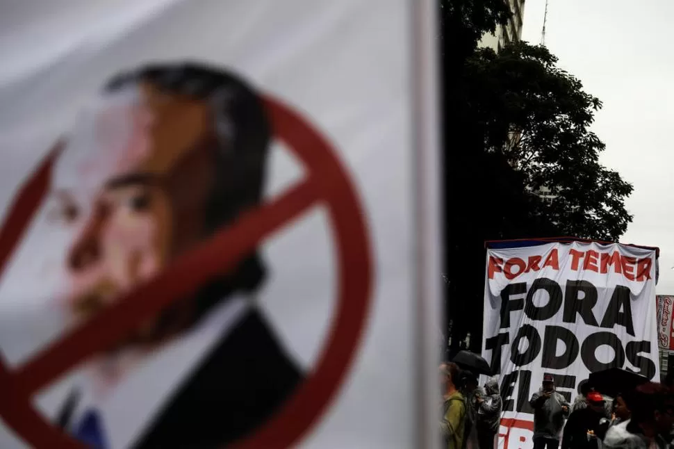 BAJO LA LLUVIA. En San Pablo, los manifestantes volvieron ayer a protestar porque Temer aún no se fue. reuters 