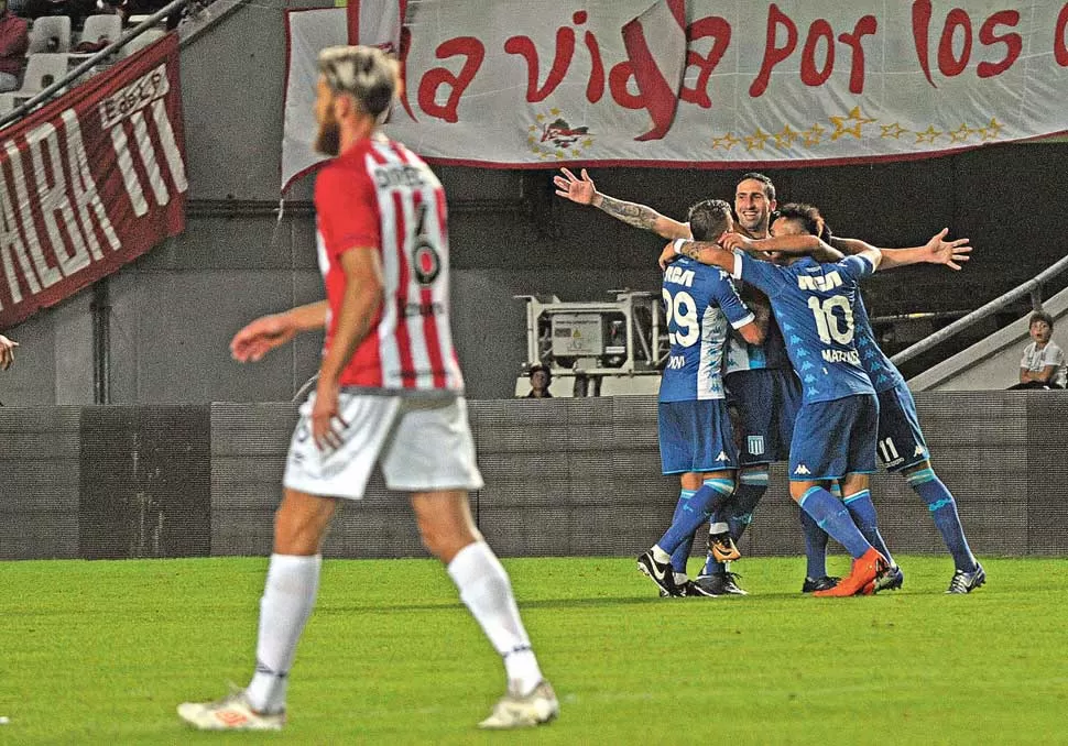 GOLEADOR. Todos en Racing abrazan a Donatti, autor del 2-0 de Racing. TELAM