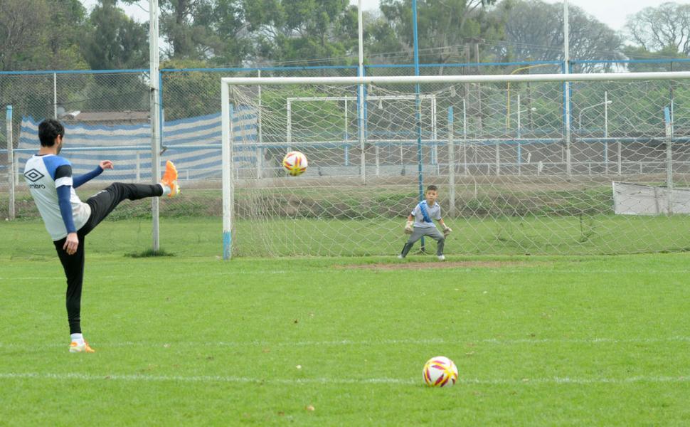 SECUENCIA. Arriba, desde la izquierda, Lucchetti primero le da los guantes a Mateo que se los pone y posa con los otros arqueros. Abajo, recibe un penal del “Laucha”. la gaceta / fotos de Antonio Ferroni