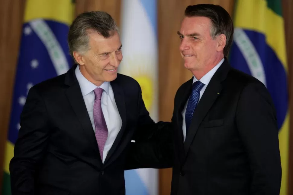 MAYORES SOCIOS. Macri y Bolsonaro pugnan por el ingreso al ALCA. reuters