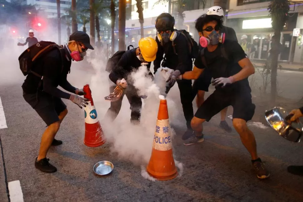 DECIDIDOS. Muchos jóvenes esquivaron durante horas a los antidisturbios.  reuters