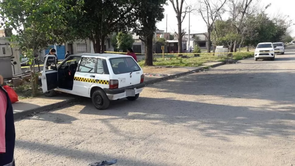 ANÁLISIS. Un perito de la Justicia analiza los impactos de bala que recibió el taxi en la avenida Papa Francisco.  