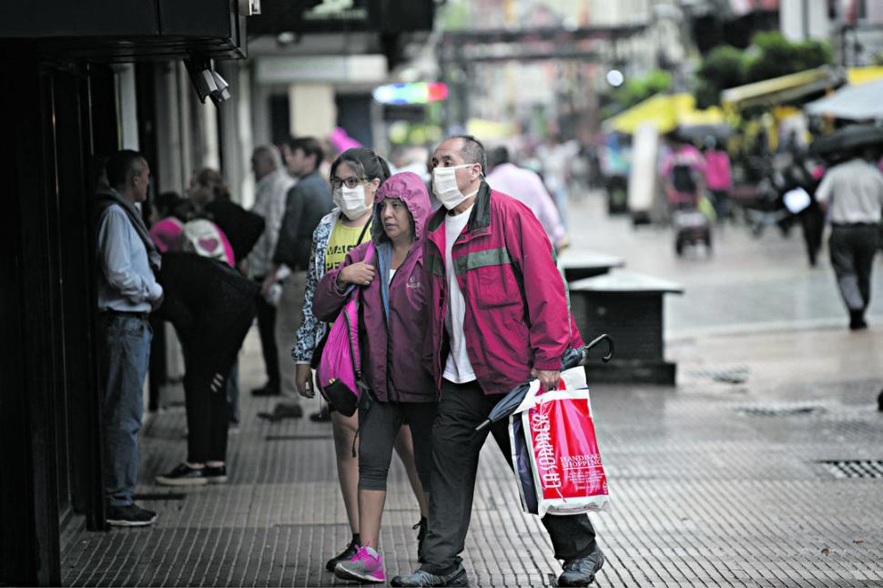 DÍA DE LLUVIA. El uso generalizado de mascarillas se produce luego de las medidas que anunció Alberto Fernández. LA GACETA/ JUAN PABLO SÁNCHEZ NOLI