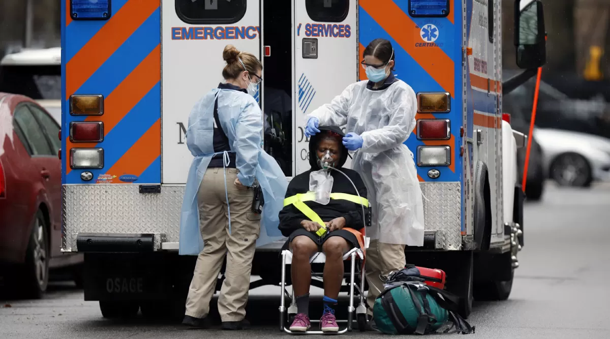 ASISTENCIA. Una mujer baja de una ambulancia para ser internada en un hospital de Nueva York.