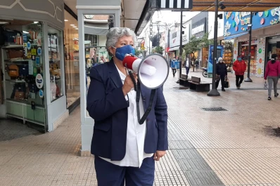 Con un megáfono dan los consejos sanitarios en las filas de los bancos