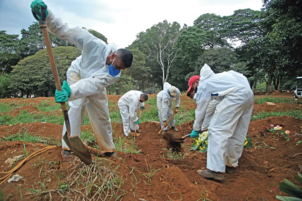 TRAGEDIA. Los enterradores del cementerio de Vila Formosa, en San Pablo, trabajan casi sin descanso. REUTERS