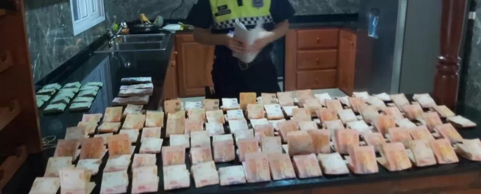 LA PRUEBA DEL DELITO. Una parte de los billetes que se secuestraron ayer en uno de los domicilios allanados por la Policía.  
