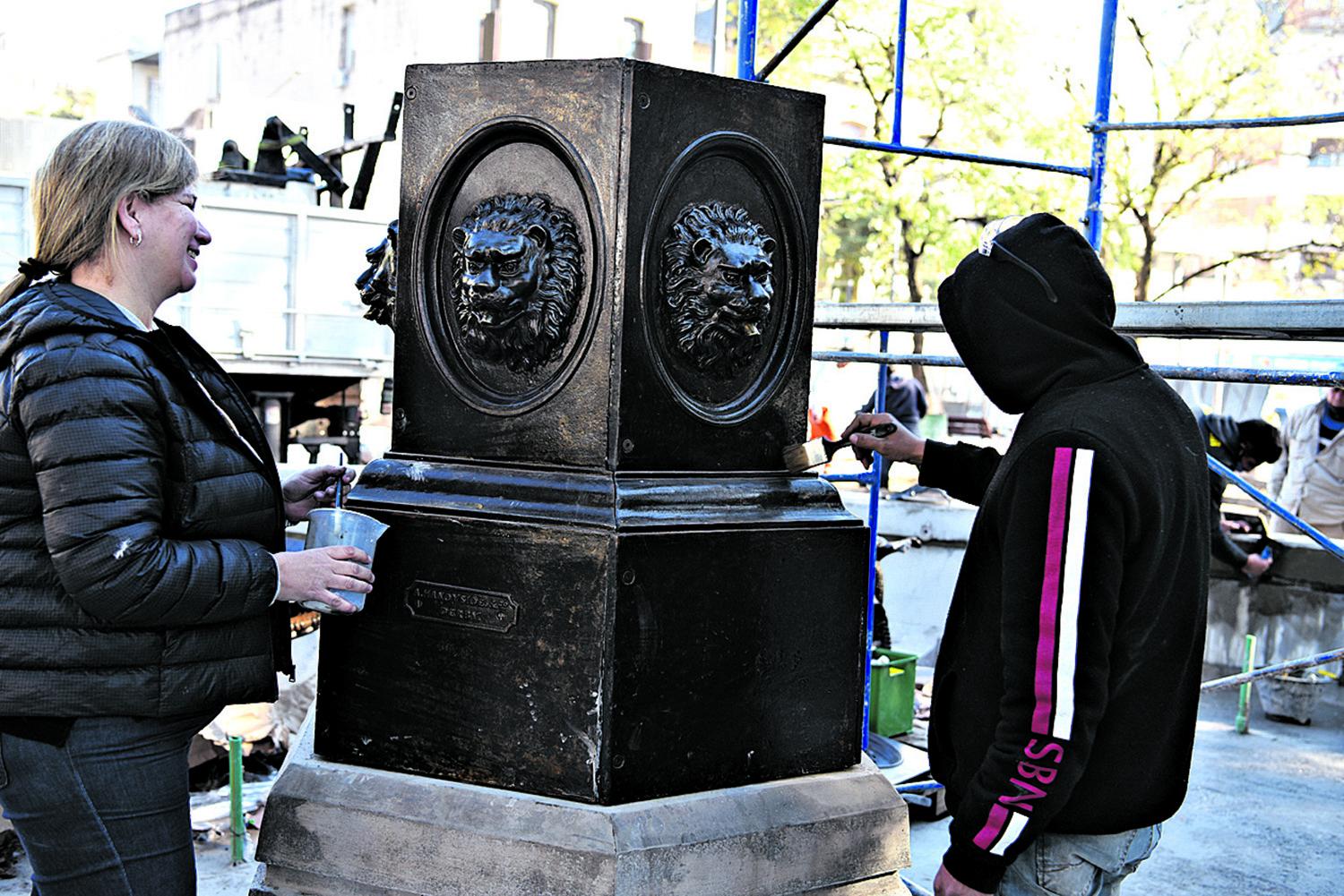 LOS LEONES. Fagalde y un operario retocan la base de la fuente que cuenta ahora con un pedestal de 70 cm.