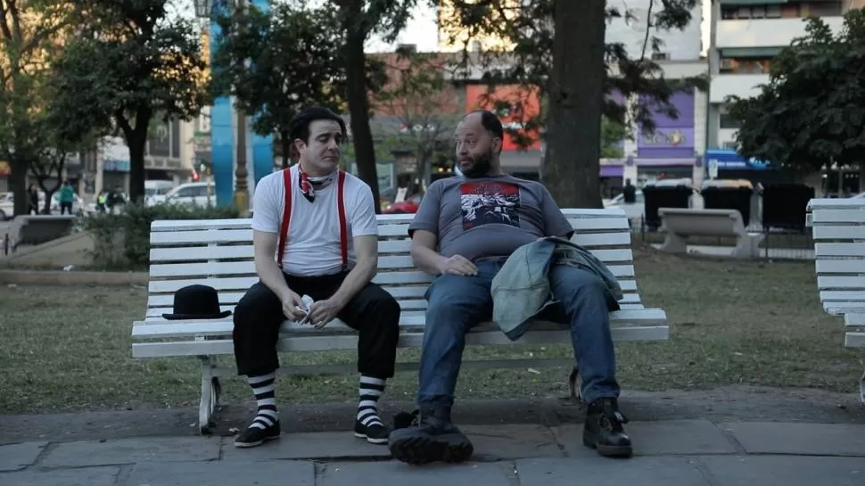 VIVIR SIN TRABAJAR. Carlos y Fefo pasan su tiempo en un bar hasta que deben pagar una abultada deuda.