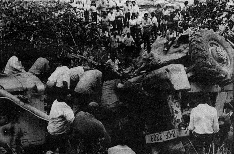 DESESPERACIÓN. Trabajadores de Vialidad intentan rescatar a su compañero luego de que se diera vuelta la máquina con la que intentaba despejar el camino que lleva a los valles