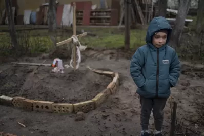 La triste historia detrás de la foto de un niño junto a la tumba de su mamá en Ucrania