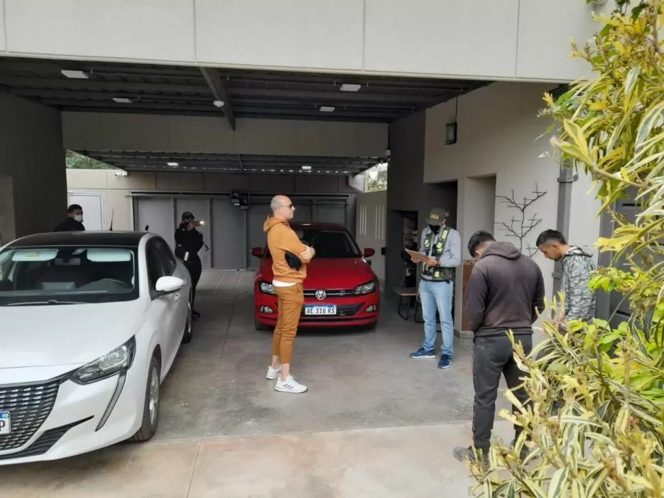 CUANDO FUE ARRESTADO. Edgar Adhemar Bacchiani espera en el garage de su casa que los gendarmes terminen con su tarea. 