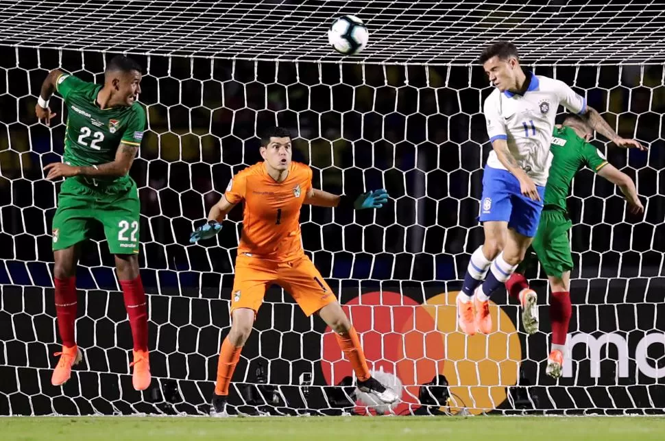 LISTO PARA ATAJAR. Carlos Lampe espera agazapado el cabezazo de Philippe Coutinho, de Brasil. El arquero es internacional con su selección desde el 2010. 