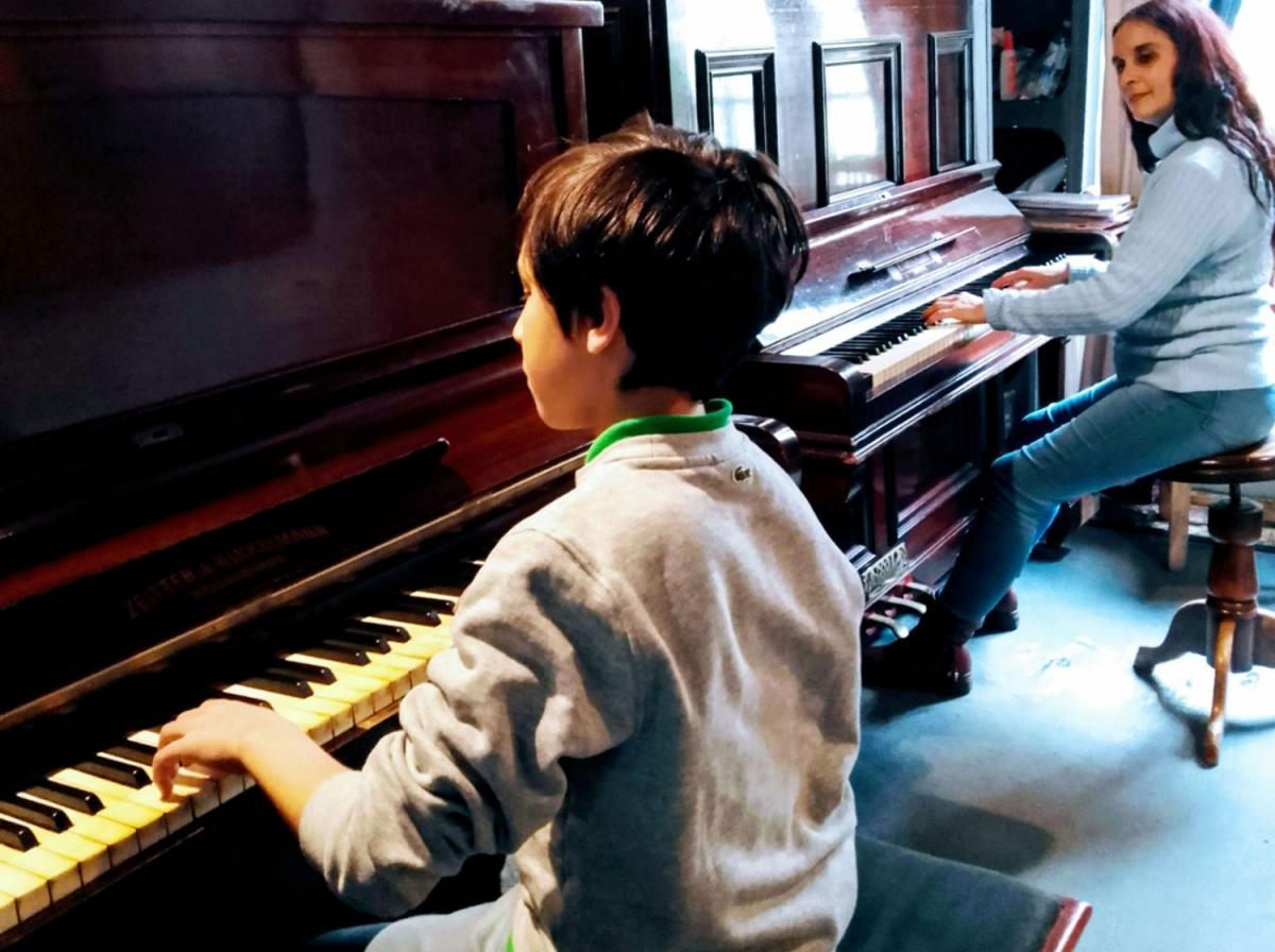 EN ACCIÓN. El niño Ciro Godoy, acompañado por su maestra Grima. 