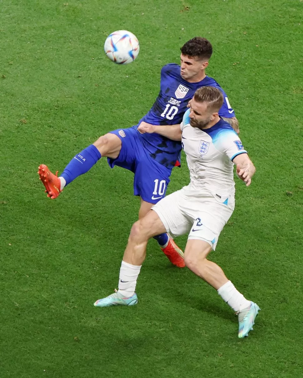 SIN TREGUA. Christian Pulisic, conductor de EE.UU., en disputa de la pelota con Luke Shaw. 