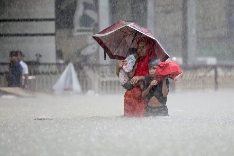 LLUVIA Y HIELO. En junio, inundaciones (arriba) pusieron bajo el agua a parte de Bangladesh. La nieve fue la protagonista durante los Juegos de Invierno 2022 de Pekín, en febrero 2022.  fotos reuters