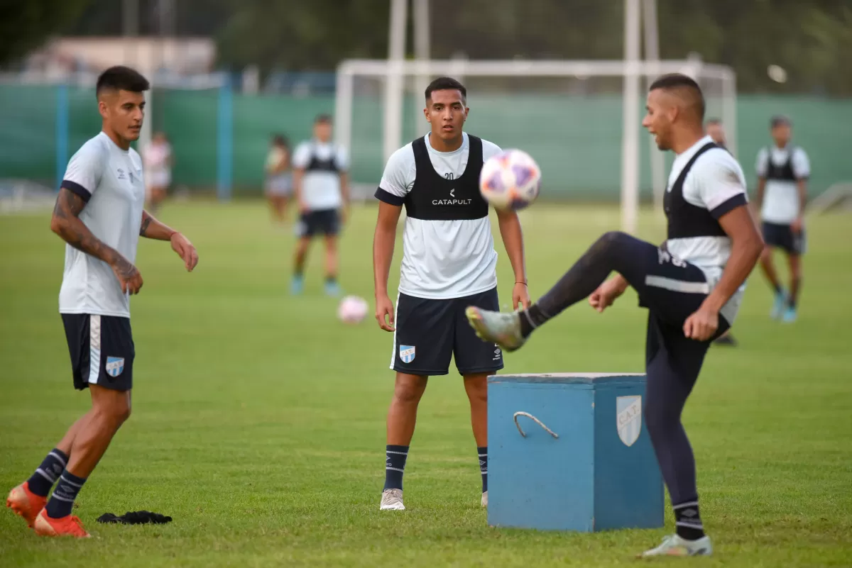 DISTENDIDOS. Nicolás Romero y Joaquín Pereyra observan a Gustavo Lescano en una de las prácticas. El central se acopló muy bien a la zaga junto a Bianchi.