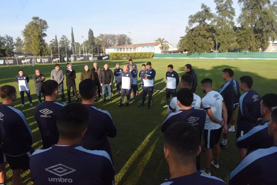 NO VOLÓ NI UNA MOSCA. Favio Orsi y Sergio Gómez tomaron la palabra, mientras los jugadores y algunos dirigentes escuchaban atentamente. La charla empezó en el campo y terminó en el comedor.  