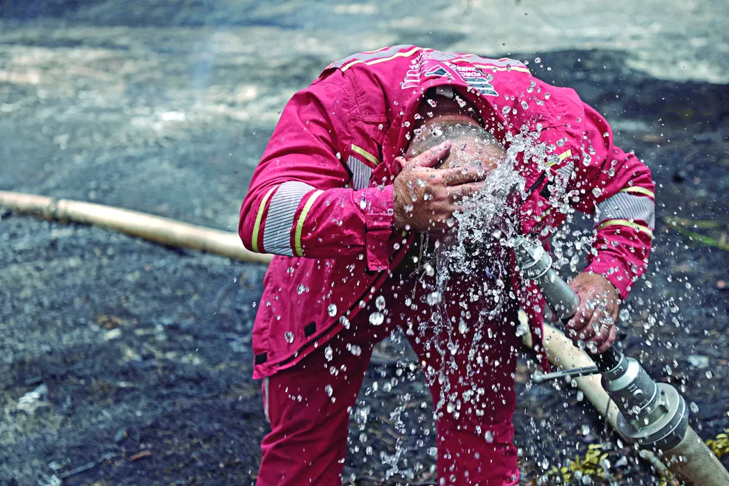 ALBANIA. Miembros de los servicios de emergencia realizan una pausa en el combate contra los incendios forestales, en el condado de Fier, a pocos kilómetros del Mar Adriático.