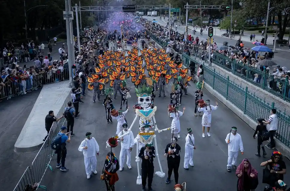 FIESTA POPULAR. Una multitud avanza por las calles, entre música, colores y  enormes figuras tradicionales que aparecen en esta celebración.
