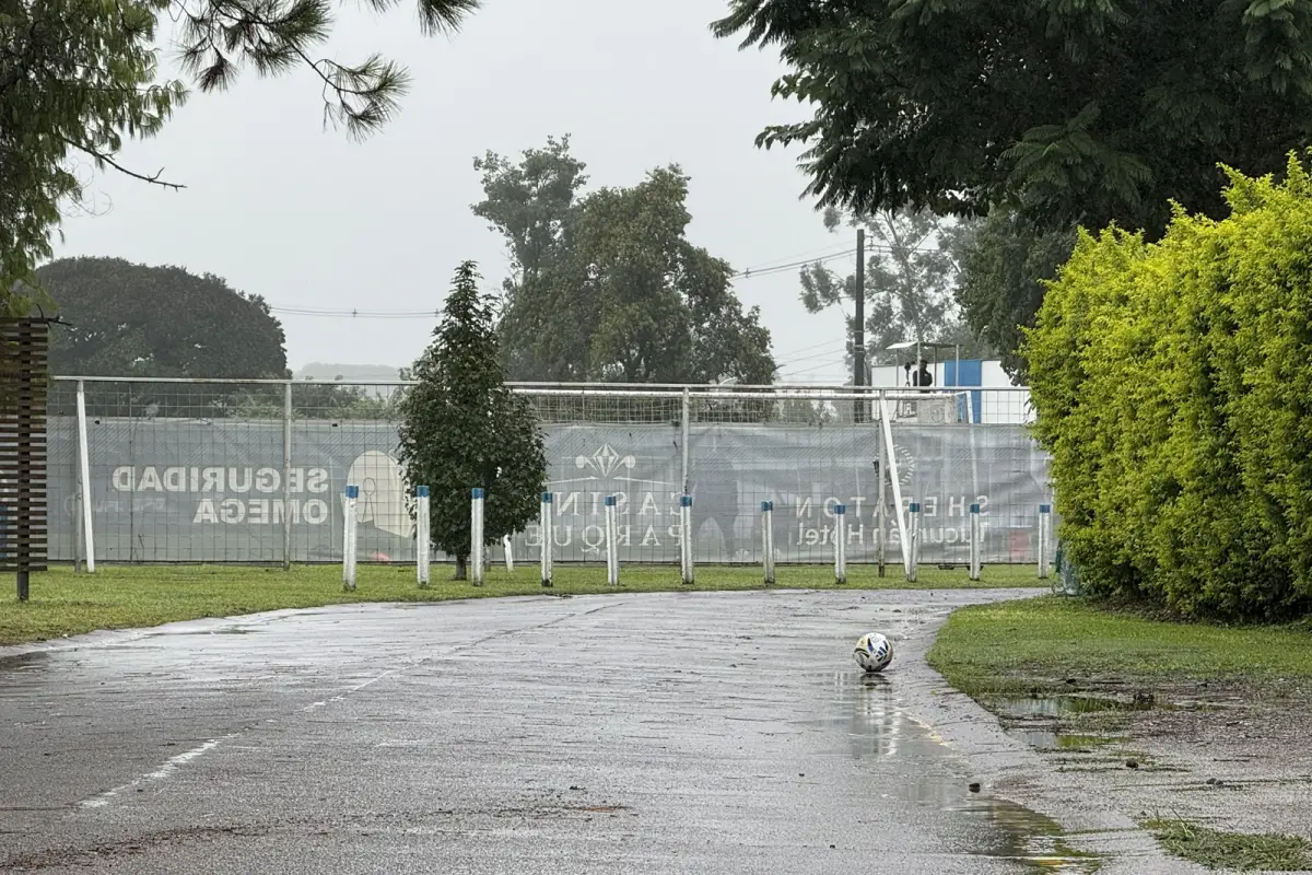 MAÑANA GRIS. Así amaneció el complejo Ojo de Agua, donde el plantel de Atlético se entrenó pensando en Gimnasia. Cerca del barro, una de las pelotas del club espera ser rescatada de la lluvia.